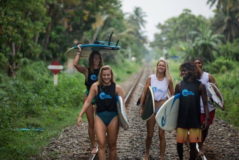 Surfers riding waves at The Surfer Beach Camp Weligama, Sri Lanka
