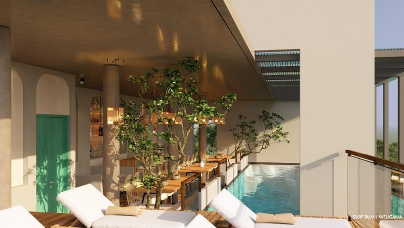 Rooftop infinity pool with loungers and planting, overlooking the ocean at Soul Surfer Camp